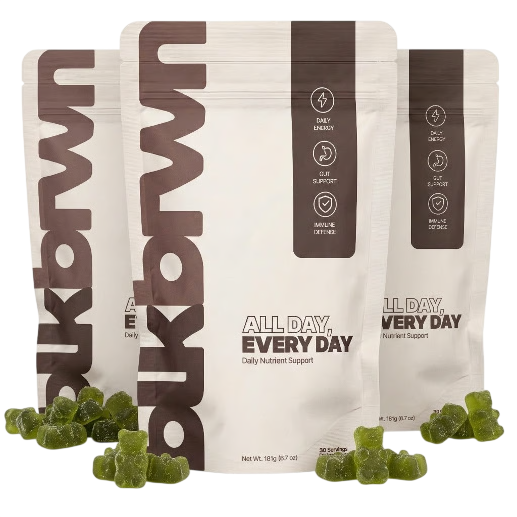 Three pouches of 'All Day, Every Day' daily nutrient support with green gummy bears scattered in front.
