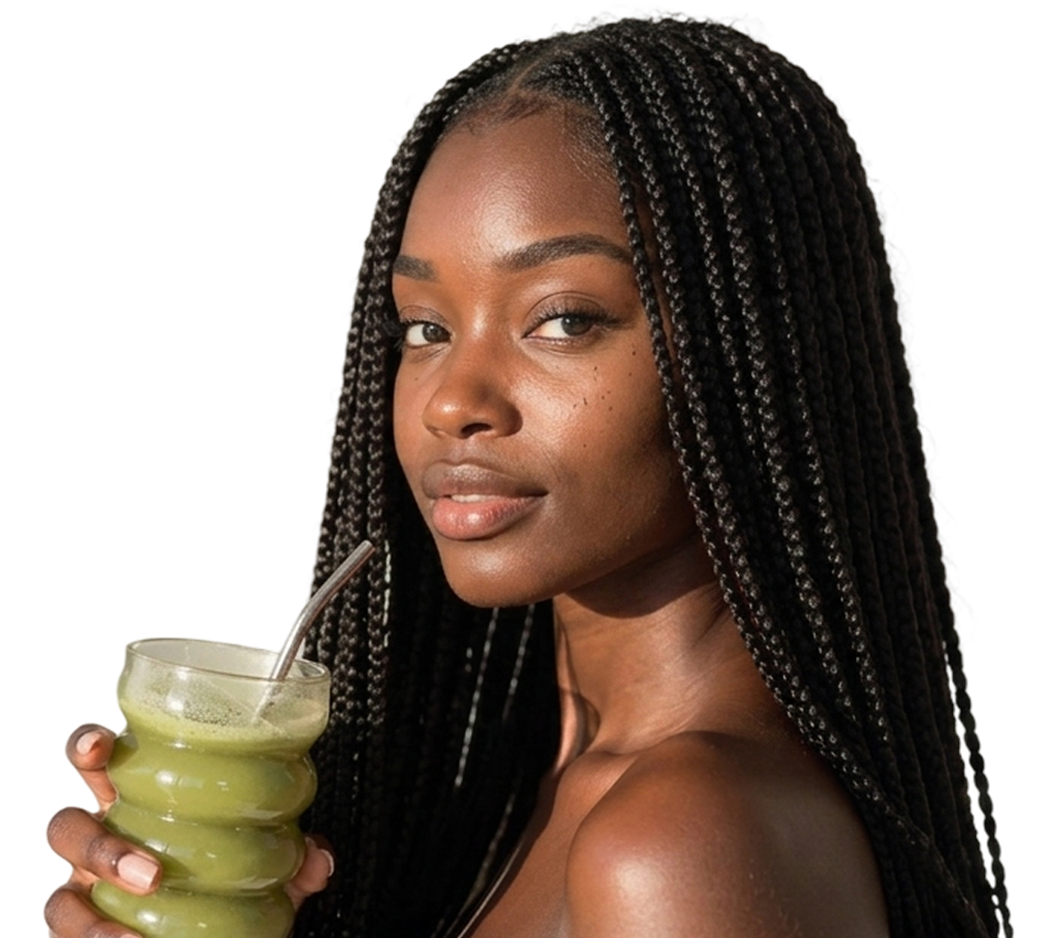 A woman with long black braids holds a glass of green juice with a metal straw.