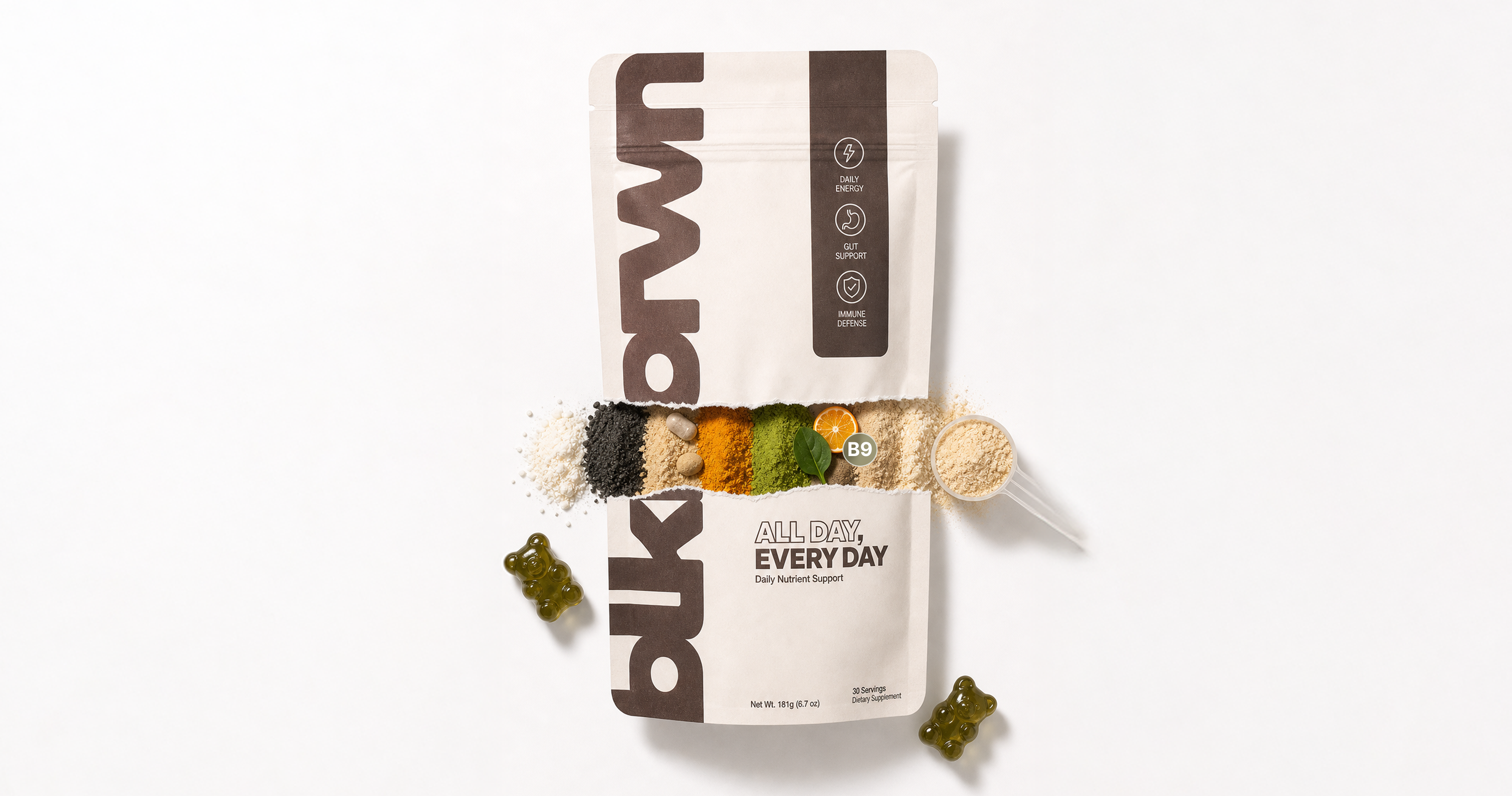 A dietary supplement pouch is torn open, revealing colorful powder ingredients, a scoop, and two gummy bears.