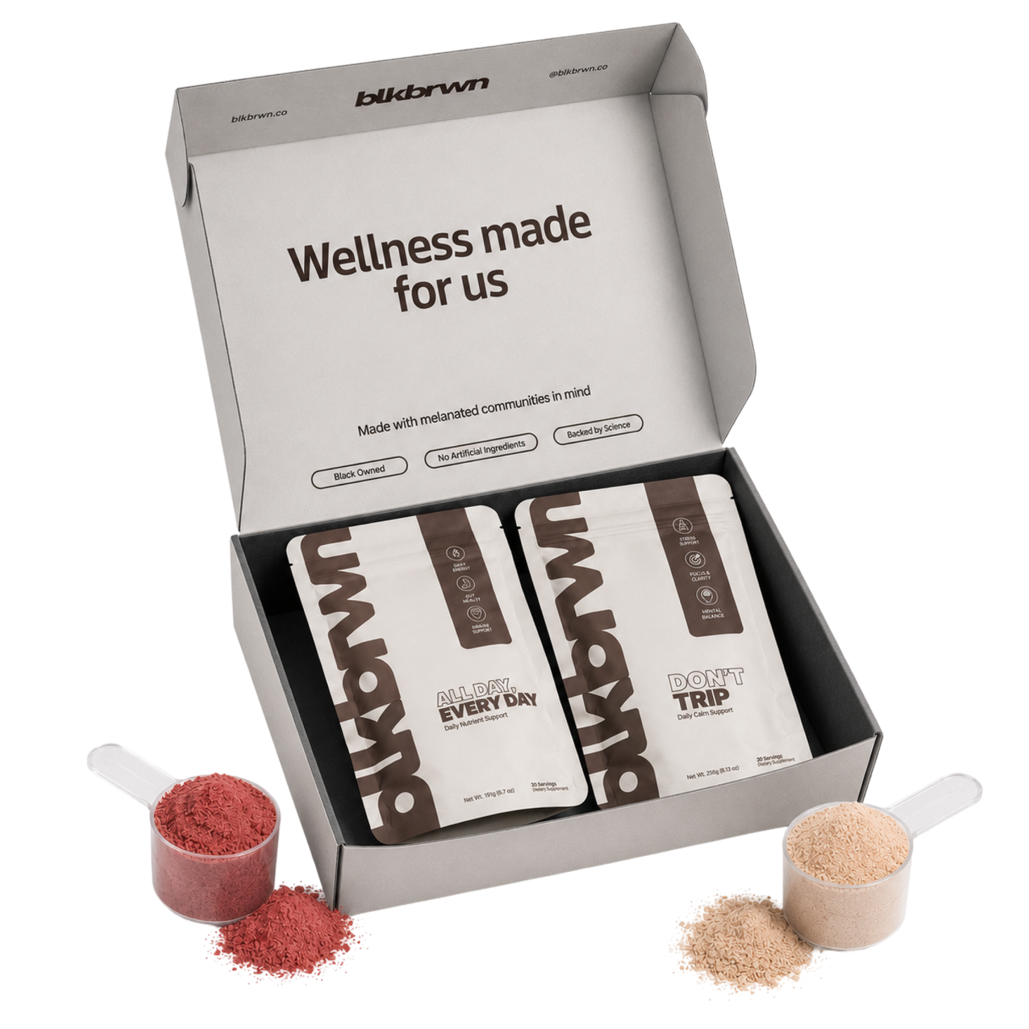 An open box of blkbrwn wellness supplements with two pouches and two scoops of powder.
