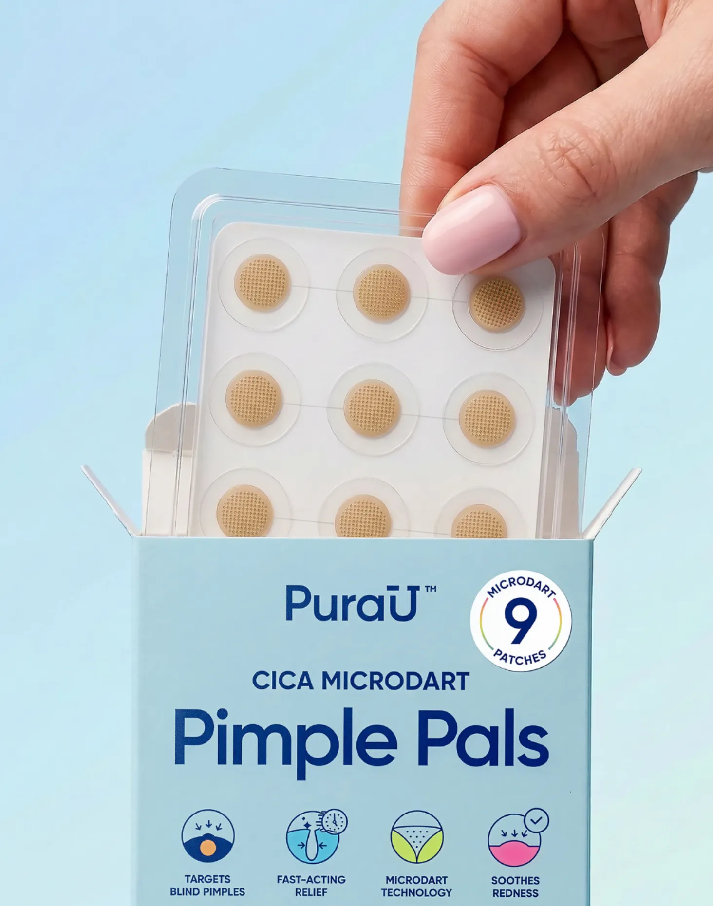 A hand with pink nails holds a clear pack of round pimple patches over an open blue box labeled 'PuraU Pimple Pals,' highlighting acne treatment.
