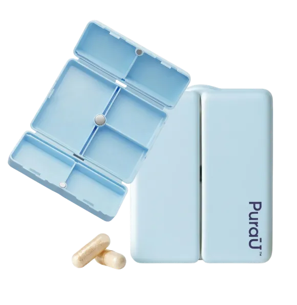 Light blue pill organizer with multiple compartments, labeled 'PuraU,' displayed open and closed. Two capsules lie nearby on a black background.