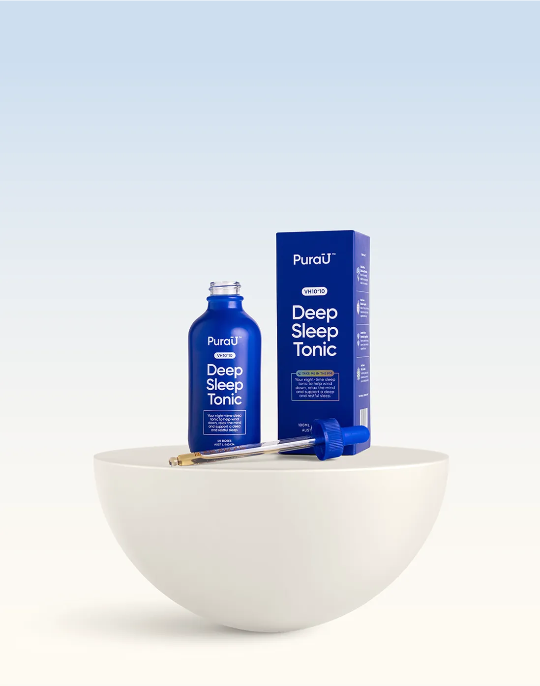 A blue bottle and box of 'PuraU Deep Sleep Tonic' on a white bowl against a gradient blue background. A dropper rests nearby, emphasizing calmness.