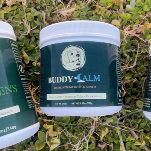 Three containers of dog supplements on grass.