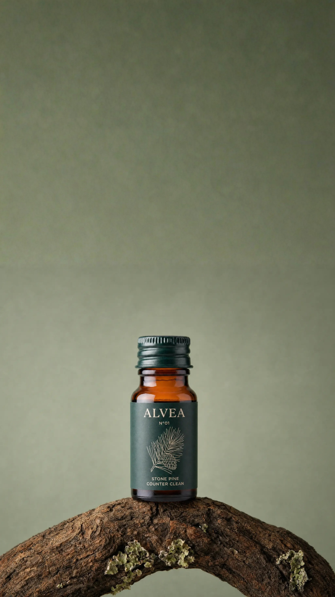 A small brown bottle of Alvea Stone Pine Counter Clean rests on a piece of lichen-covered bark.