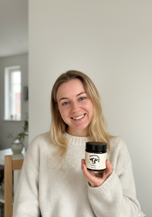 Person holding a jar labeled 'Whippy Cow Skincare' with a cow logo.