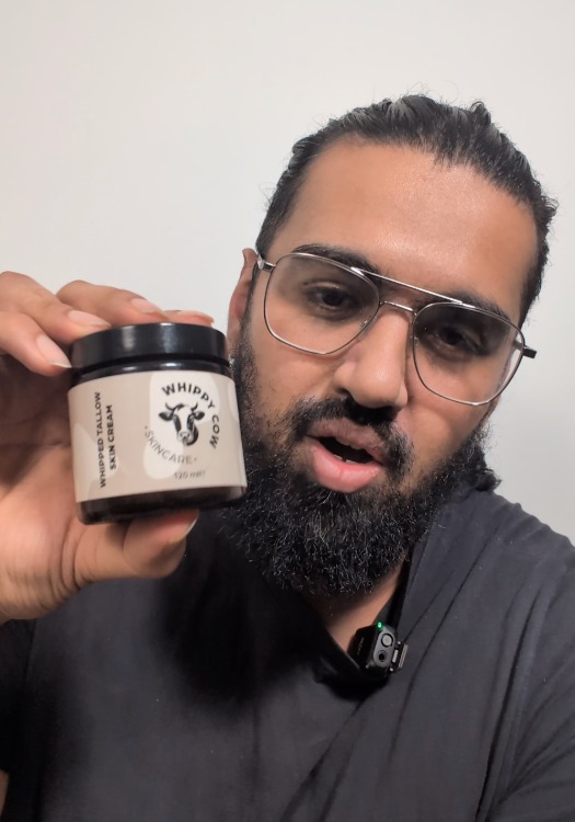 Person holding a jar labeled 'Whippy Cow Skincare' with a cow logo.
