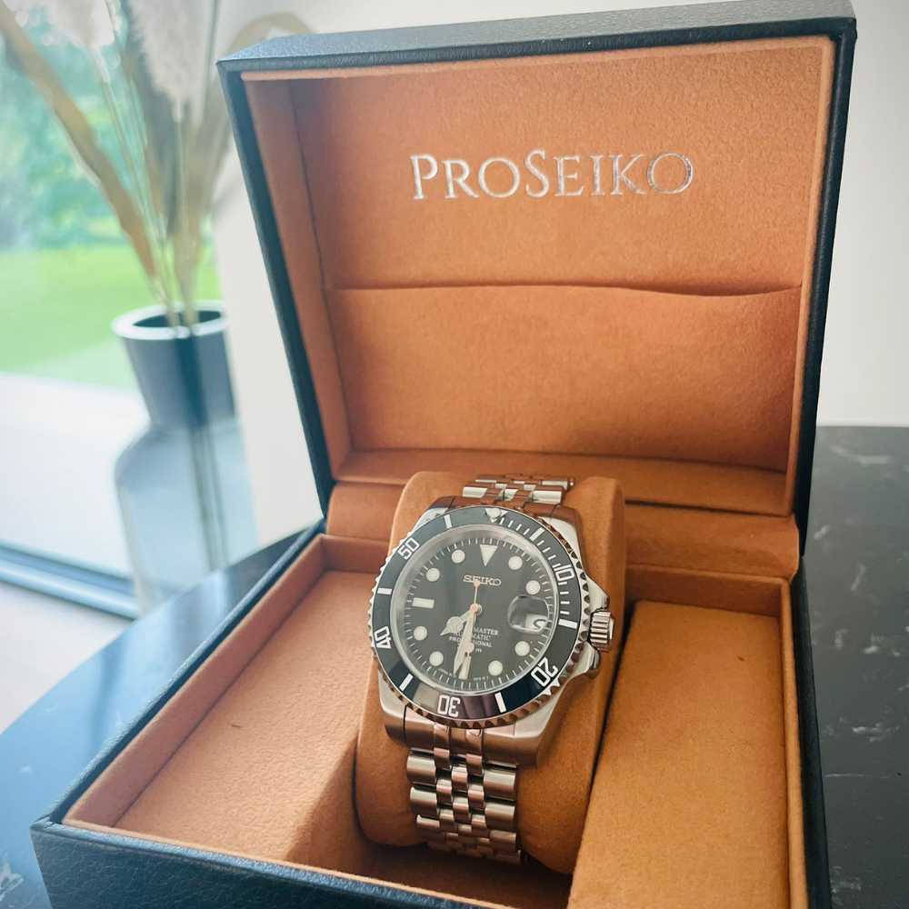 ProSeiko watch in a brown case on a table.