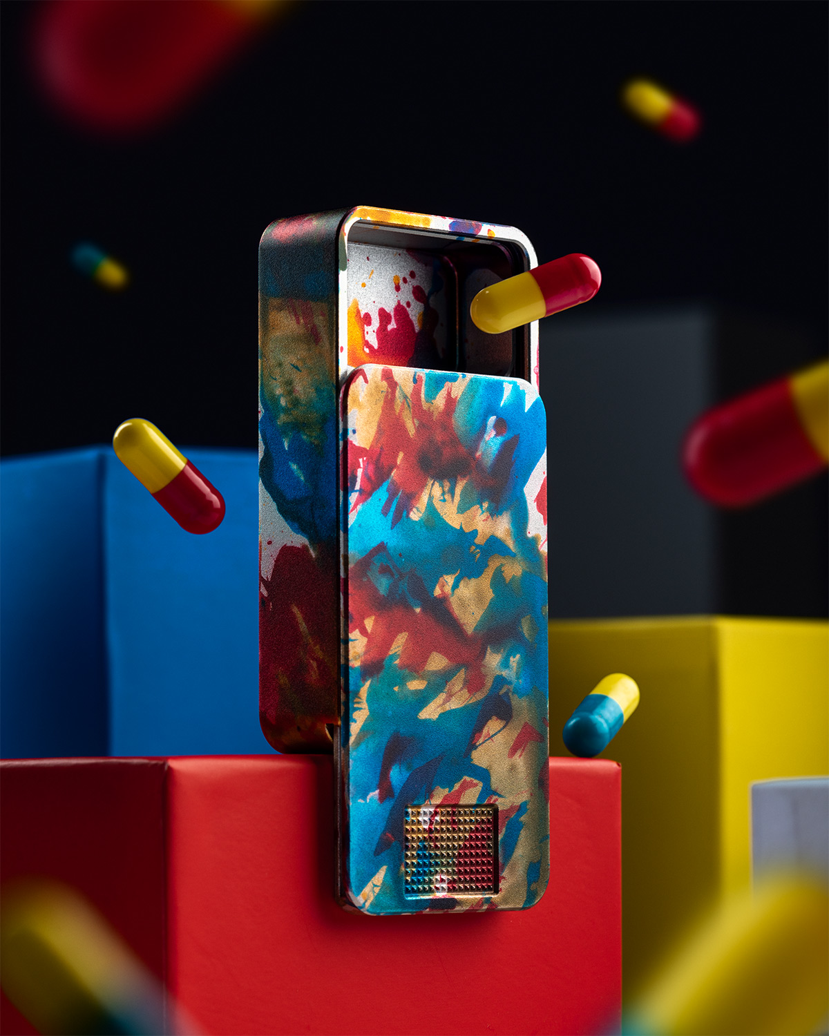Colorful tin box with abstract design and floating capsules.