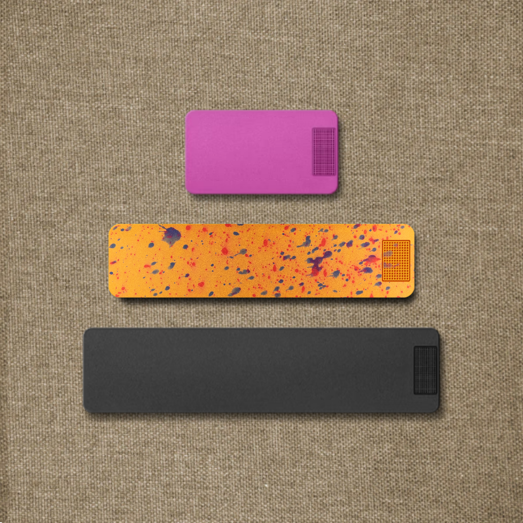 Three colorful rectangular tags of different sizes on a textured brown background.