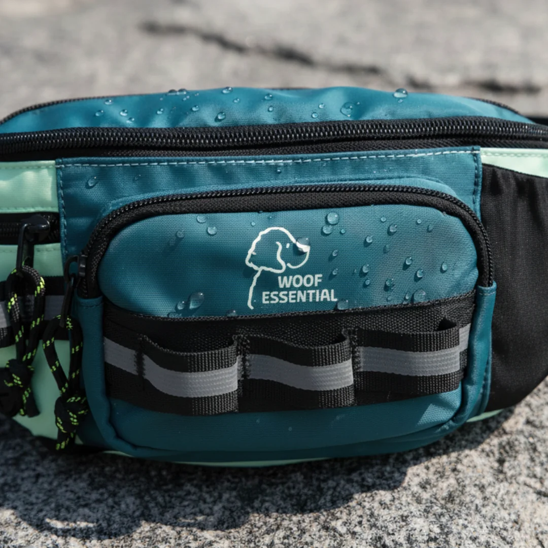 A teal and black bag with water droplets and 'Woof Essential' logo.