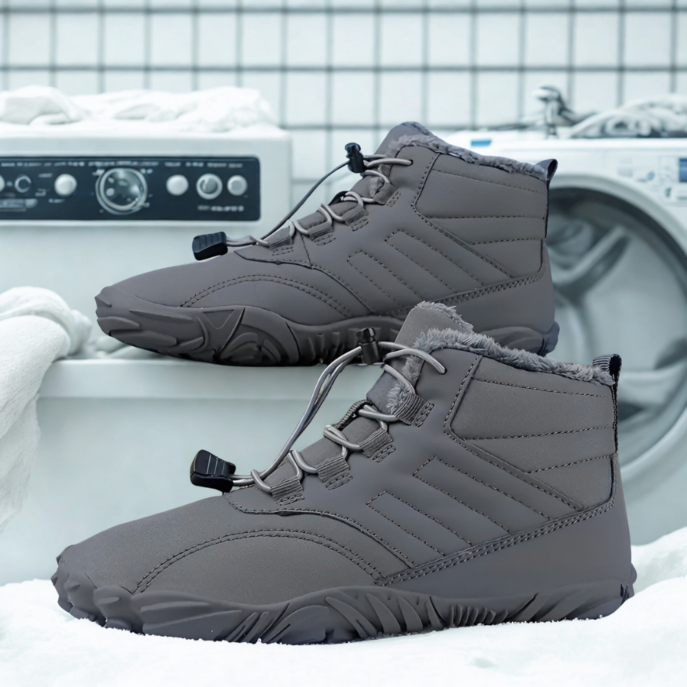 Gray winter boots with fleece lining on a washing machine, white tiled background.
