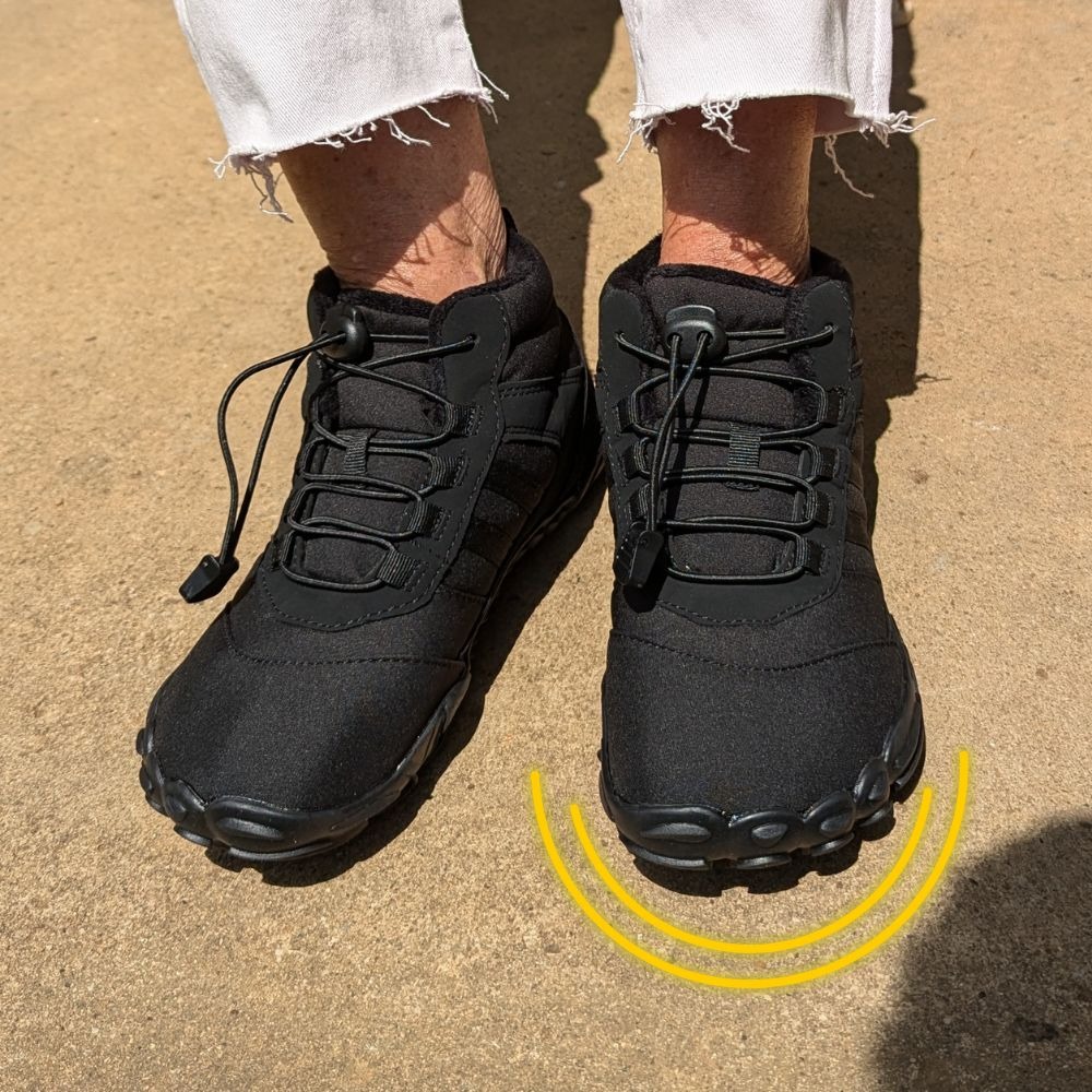 Black sneakers with white frayed pants on concrete surface.