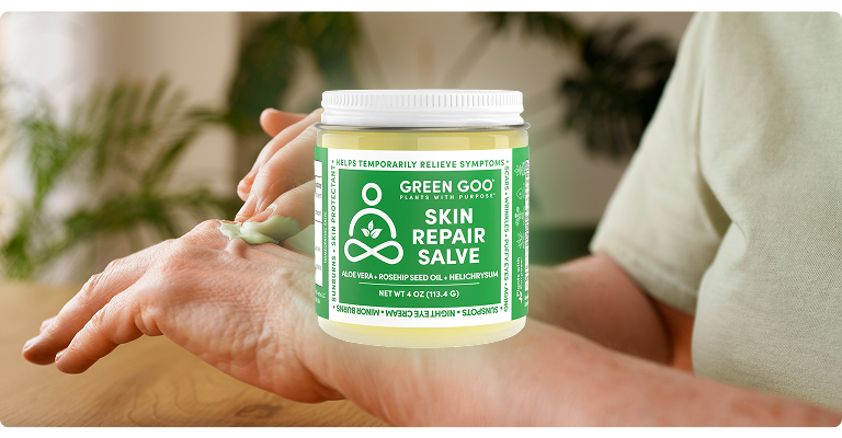 Person applying Green Goo Skin Repair Salve to their hand.