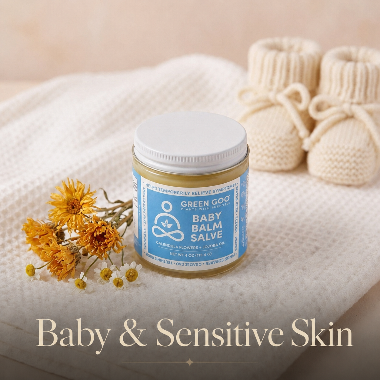 Jar of Baby Balm near Calendula herbs and baby shoes