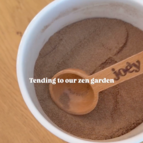 Wooden spoon in a bowl of sand with text overlay 'Tending to our zen garden.'
