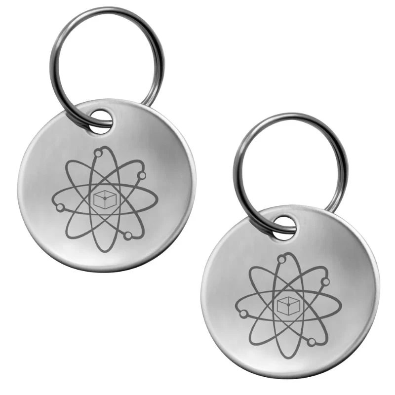 Two metal keychains with atomic symbol engravings.