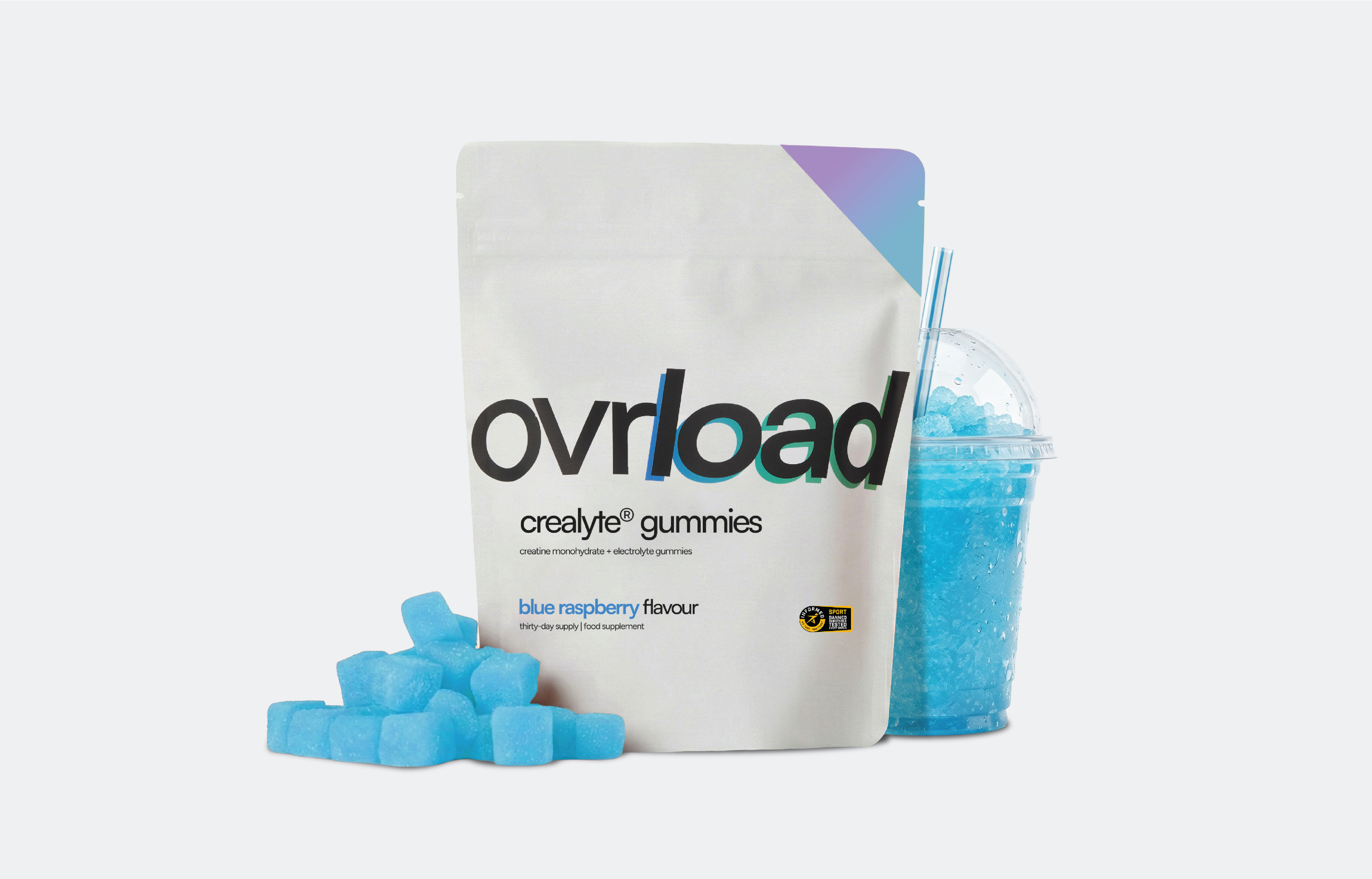 A pouch of Ovrload blue raspberry gummies with loose gummies and a matching blue slushie on a white background.