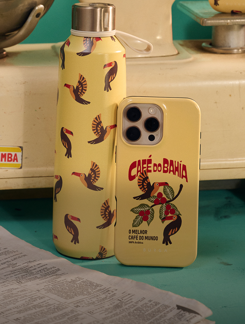 Yellow bottle and phone case with toucan design on a table.