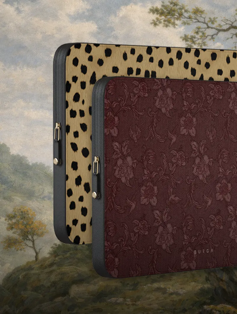 Two laptop sleeves, one leopard-print and one floral maroon, against a painted landscape background.