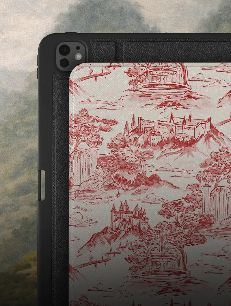 A close-up of a tablet in a black case with a red and white toile patterned cover.