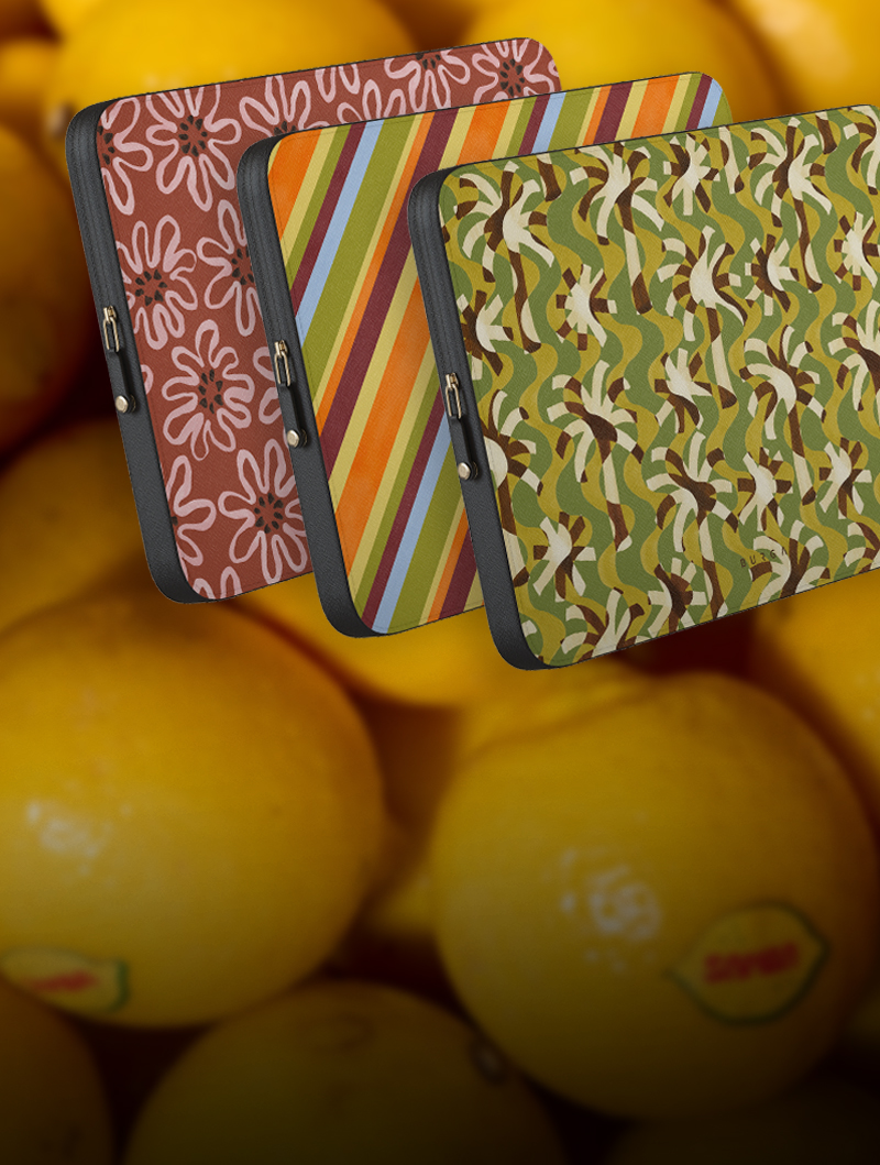 Three patterned tablet cases over a background of lemons.