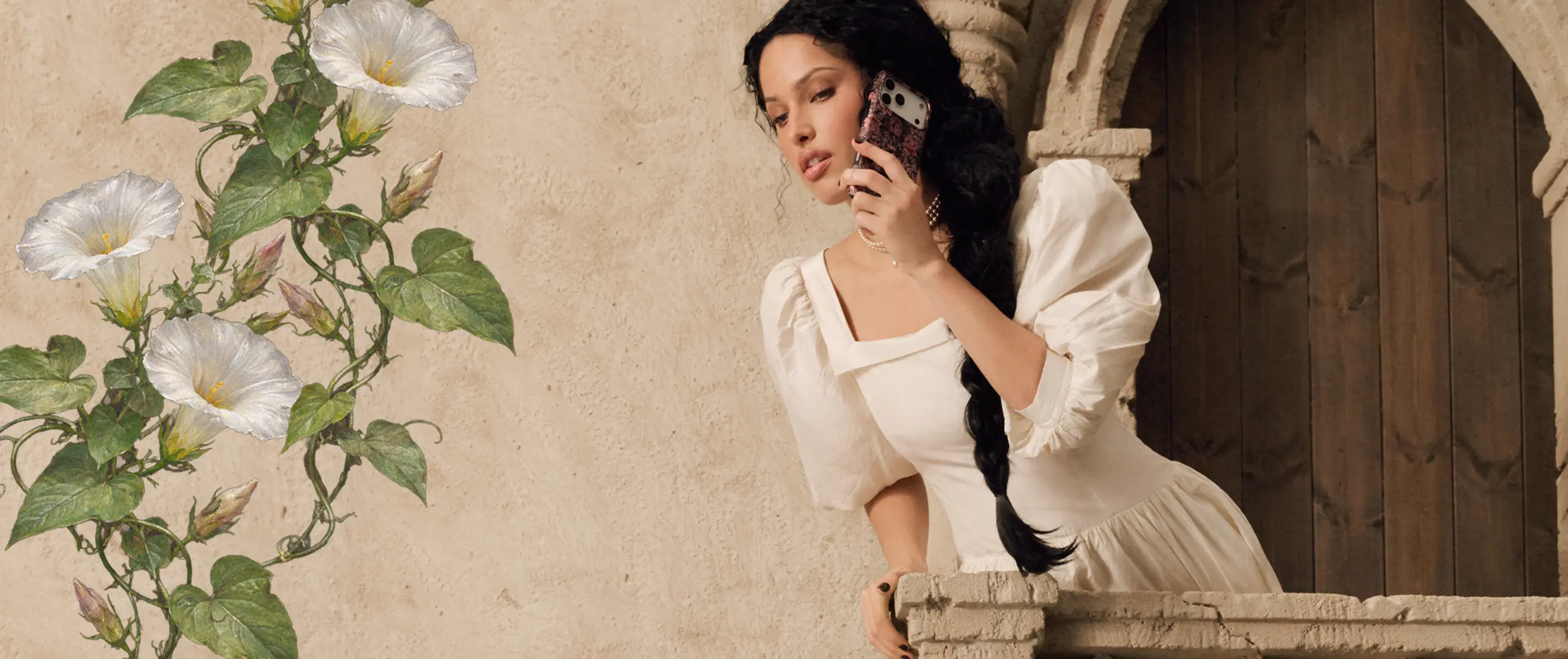 A woman in a white dress holds a phone to her ear while leaning over a stone balcony.
