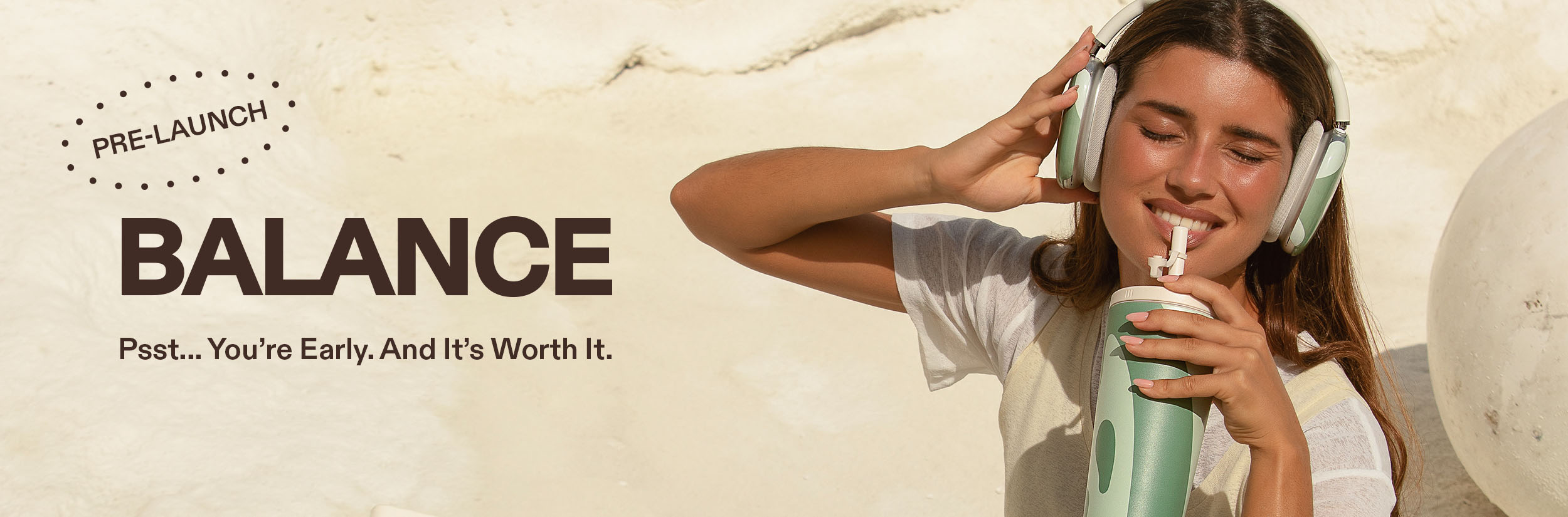 Woman wearing headphones, drinking from a bottle, with 'Balance' text on the left.