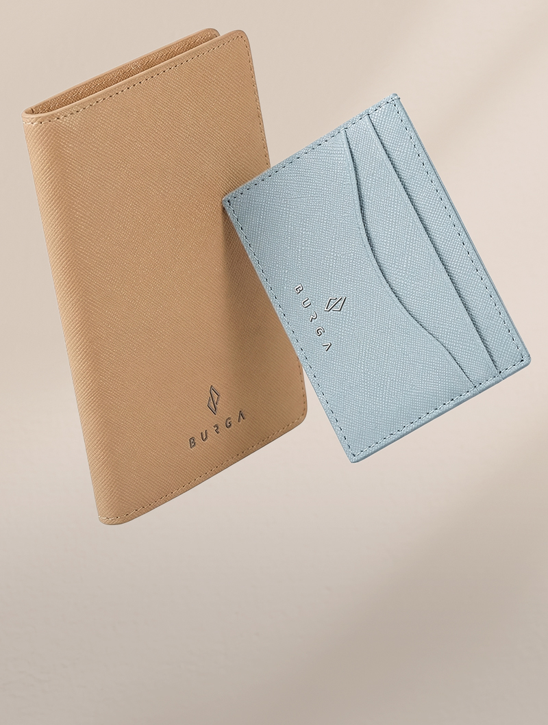 A tan passport holder and a light blue card holder with the brand name BURGA on them.