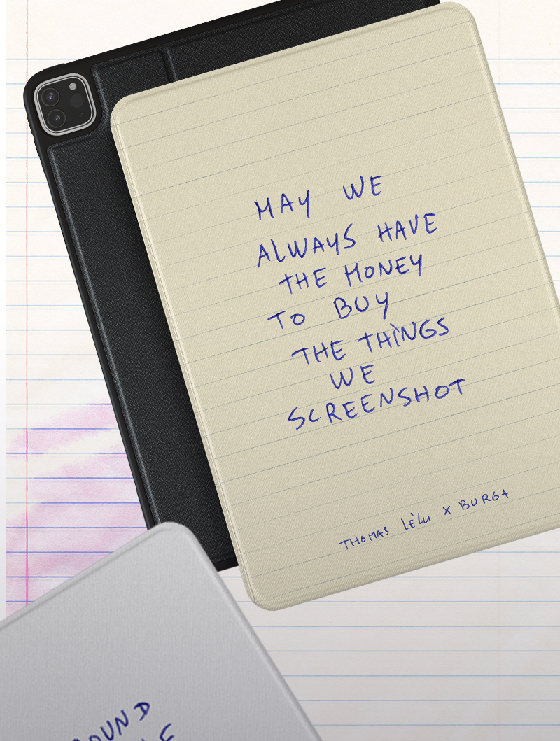 Close-up of notebooks with text: May we always have the money to buy the things we screenshot.