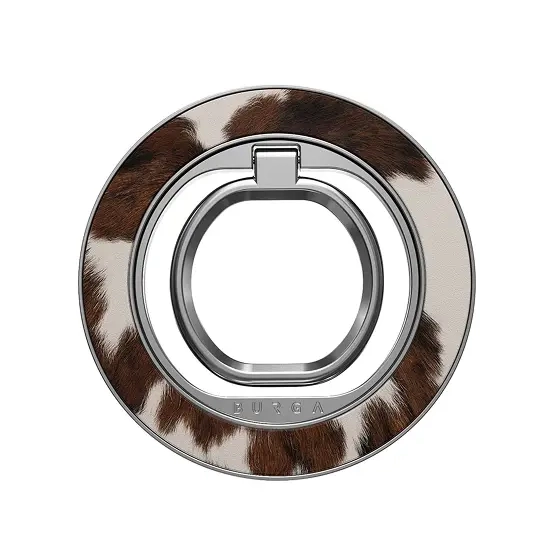 A circular phone ring holder with a brown and white cowhide print and a silver inner ring.
