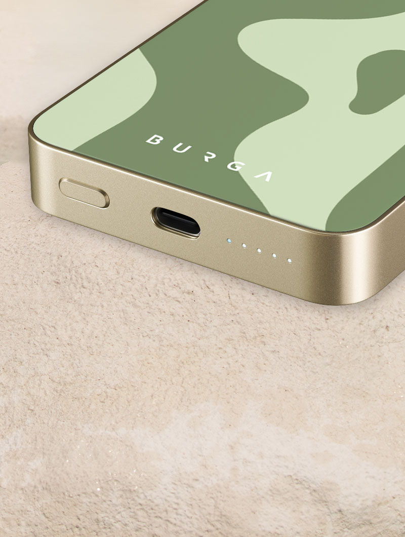 Close-up of a phone with a green abstract design case on a textured surface.