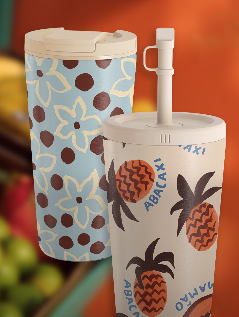 Two decorated tumblers with floral and pineapple patterns.