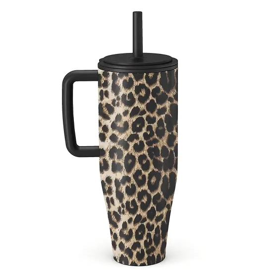 A leopard-print travel mug with a black handle, lid, and straw on a white background.