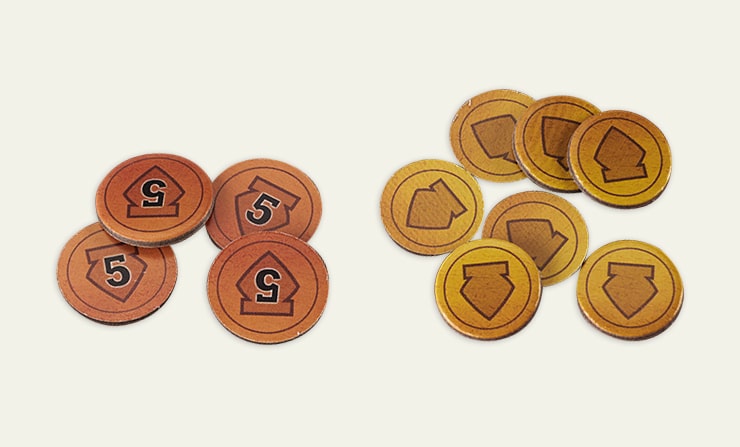 Board game tokens with various symbols and numbers displayed on a neutral background.
