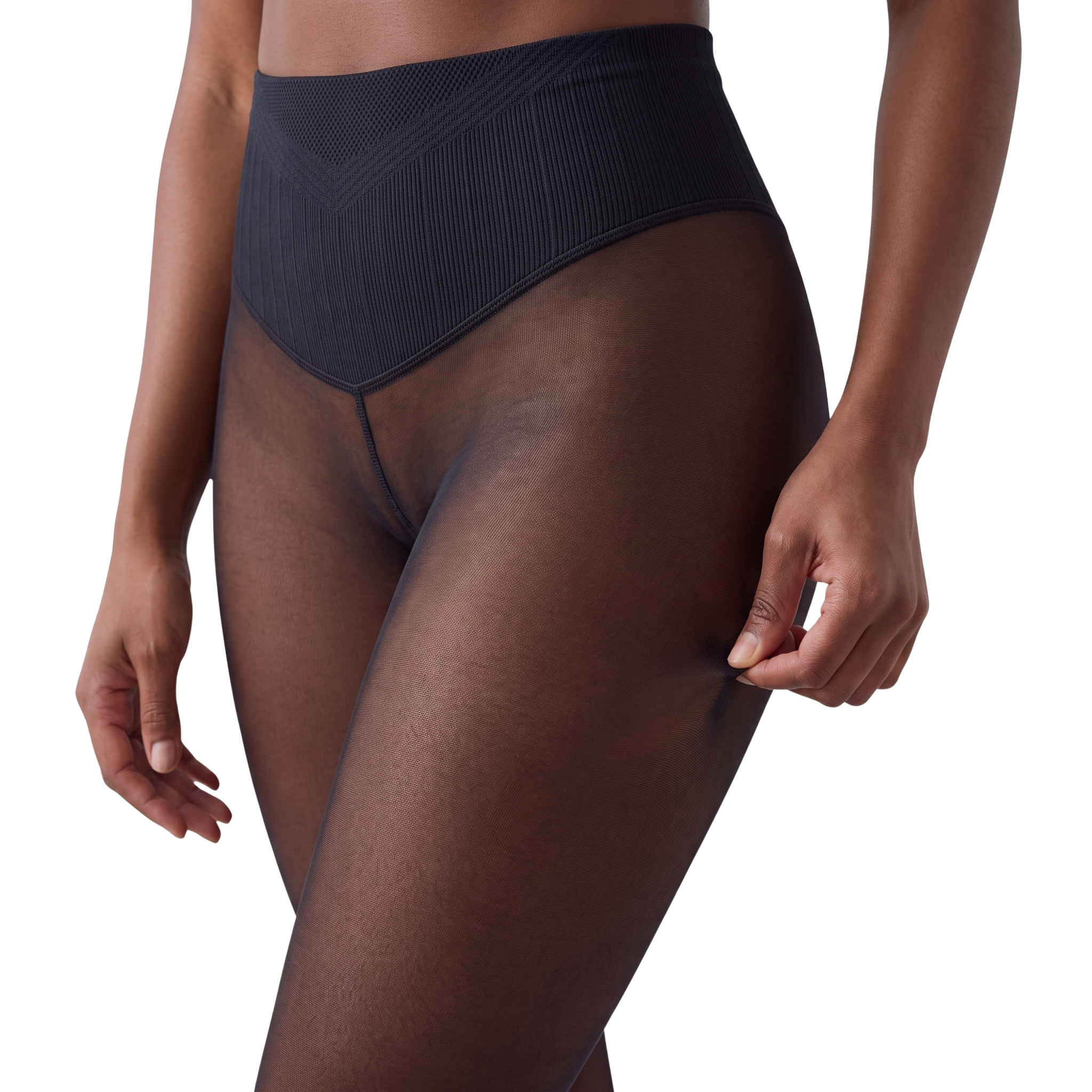 A close-up of a person's midsection wearing sheer black tights with a high, ribbed waistband.