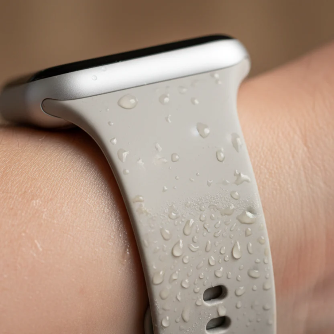 Close-up of a smartwatch with water droplets on the strap.