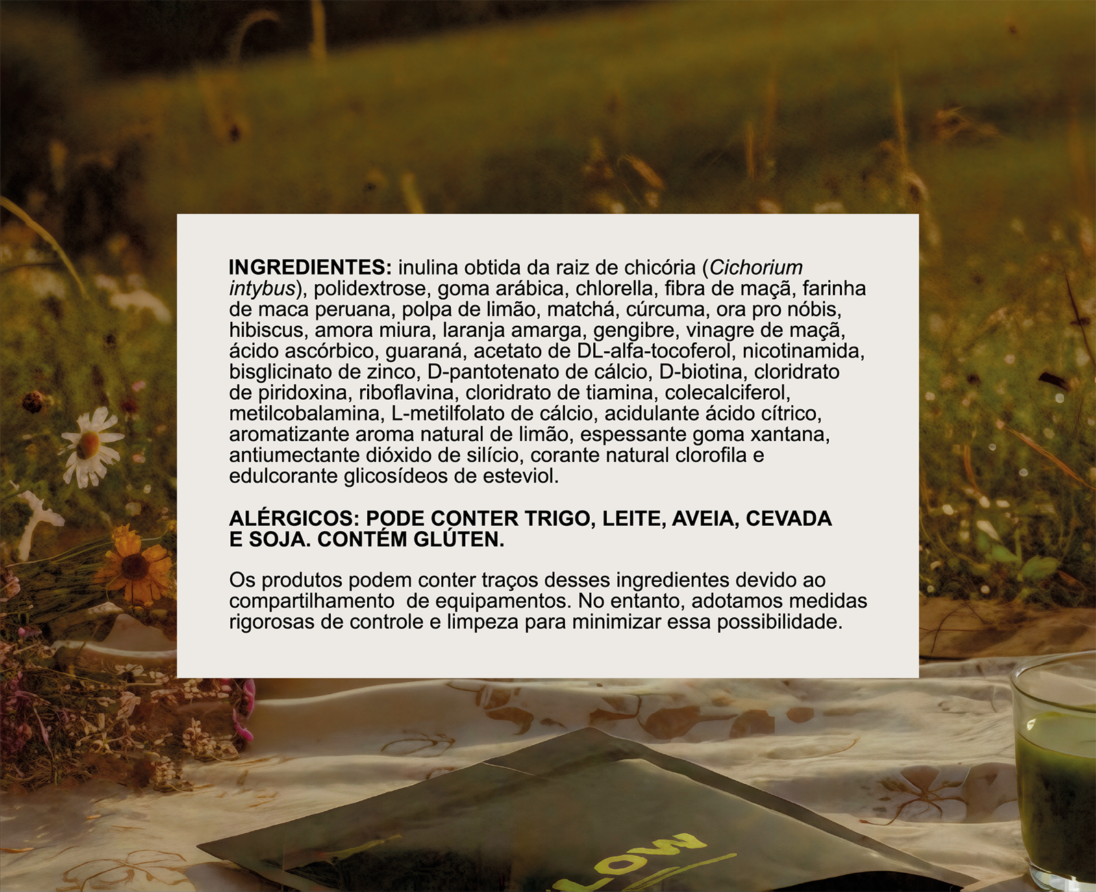 A product's ingredient and allergen list in Portuguese, with dried flowers and a green drink in the background.