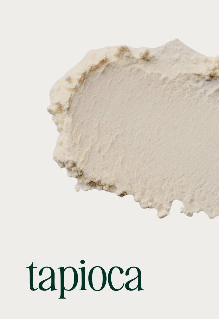 A textured smear of white powder against an off-white background with the word 'tapioca' written below.