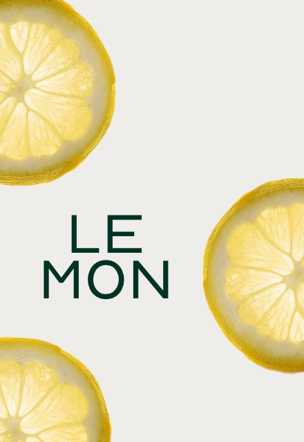 Three translucent slices of lemon on a light background with the word 'LEMON' in dark green text.