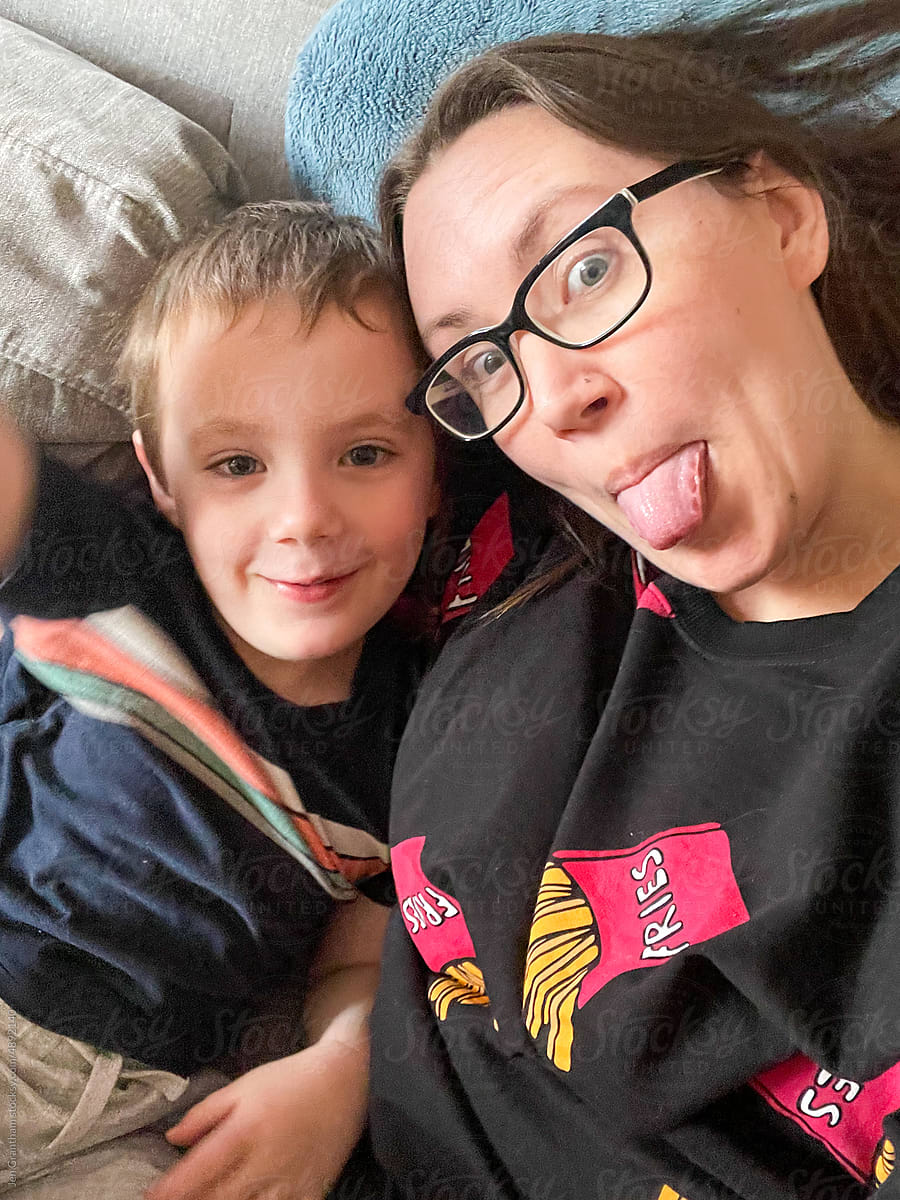 Woman and child making funny faces on a couch.