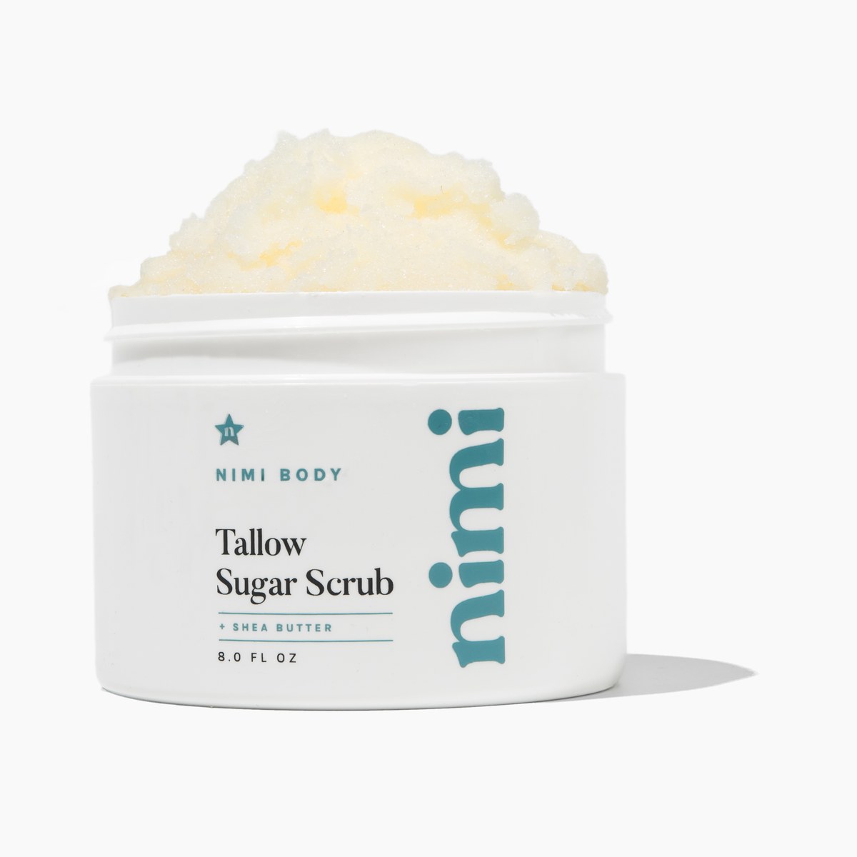 An open white jar of Nimi Body Tallow Sugar Scrub against a white background.