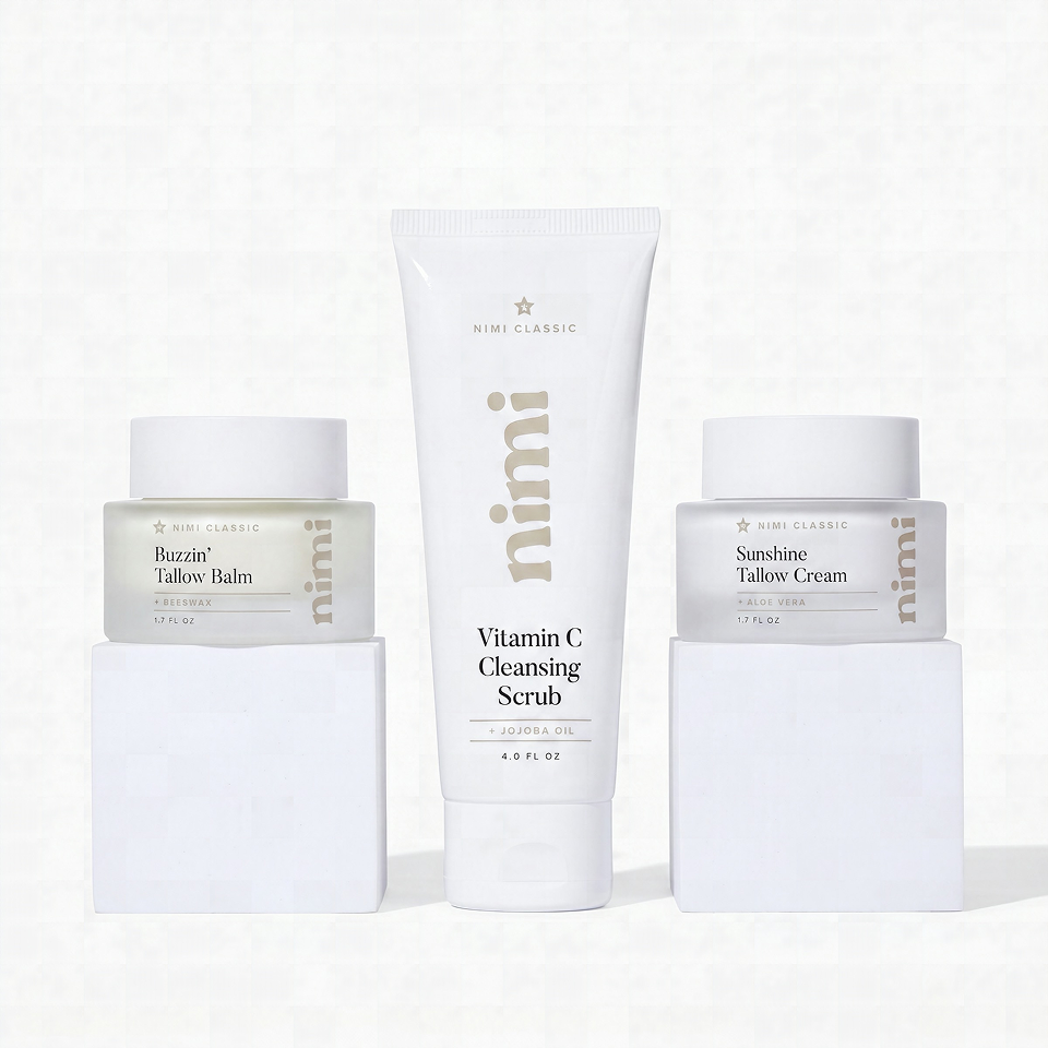 Three Nimi Classic skincare products, a scrub, balm, and cream, on white blocks.