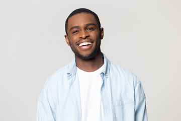 Smiling person wearing a light blue shirt against a plain background.