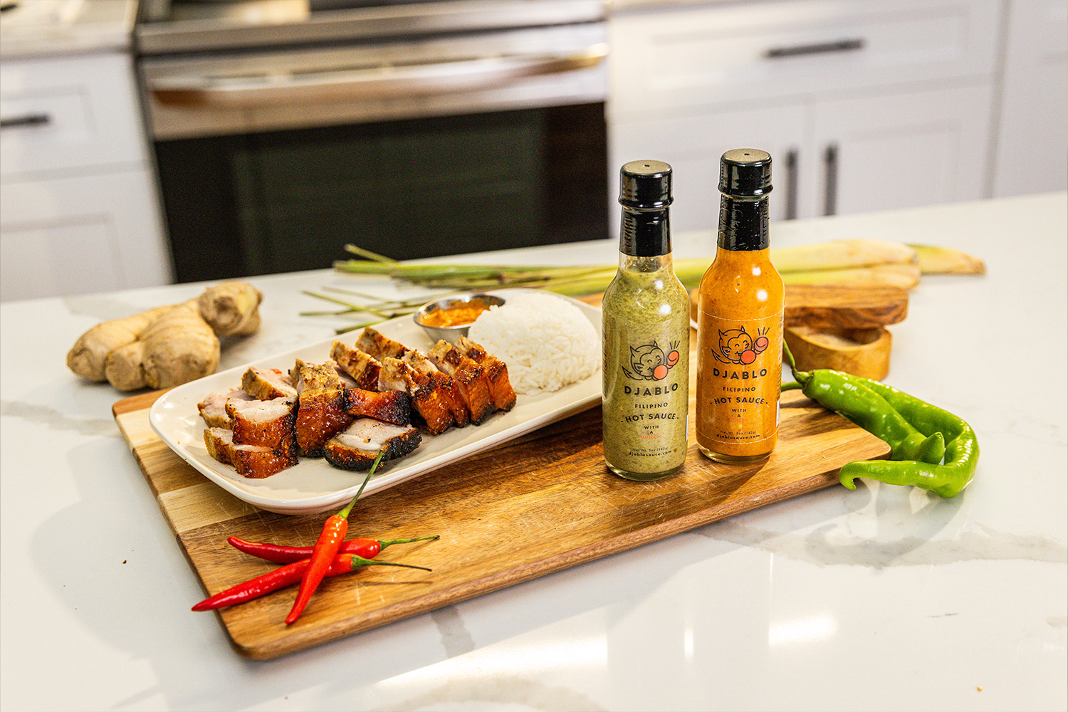 Sliced meat, rice, and hot sauce bottles on a wooden board in a kitchen setting.