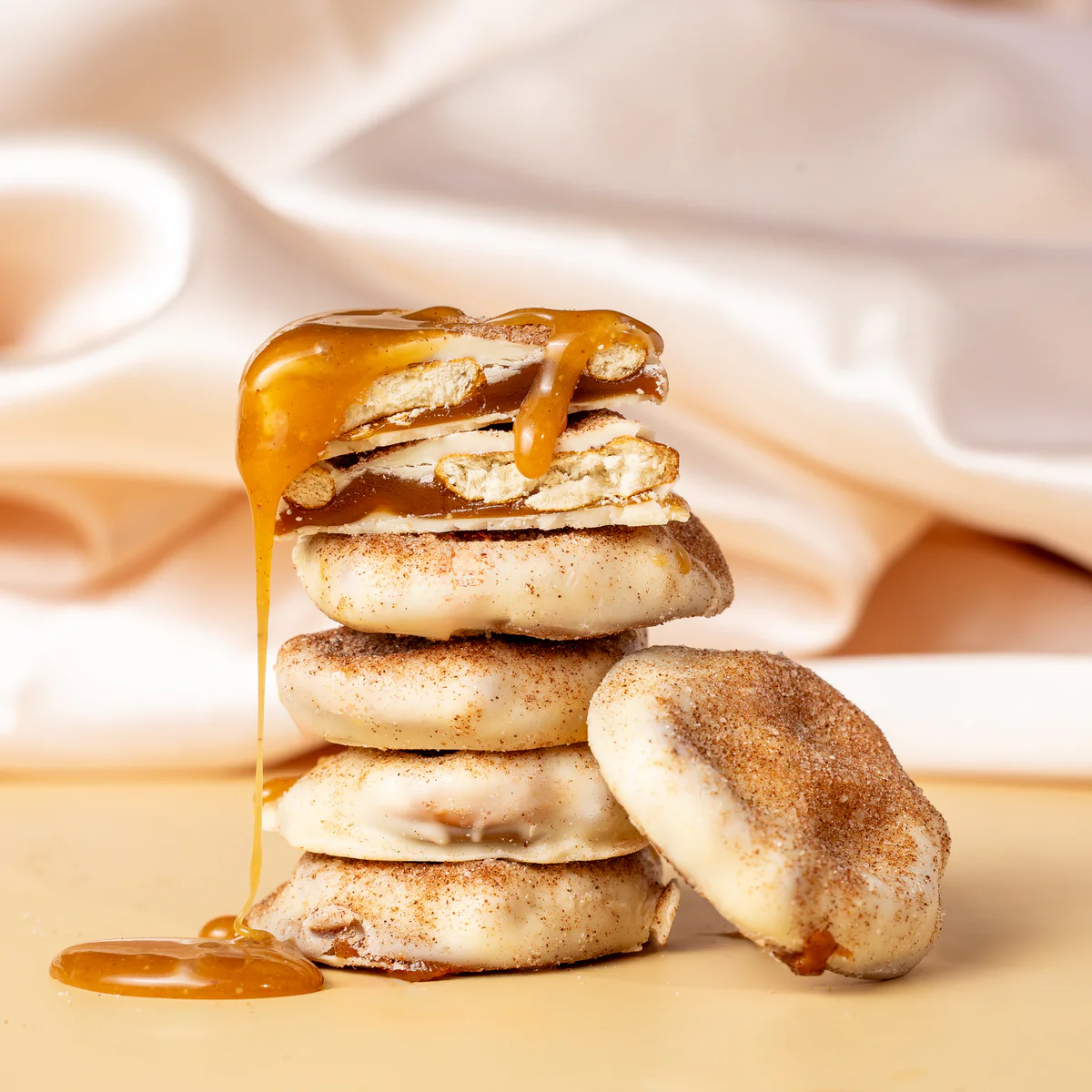 Stack of cookies topped with dripping caramel.