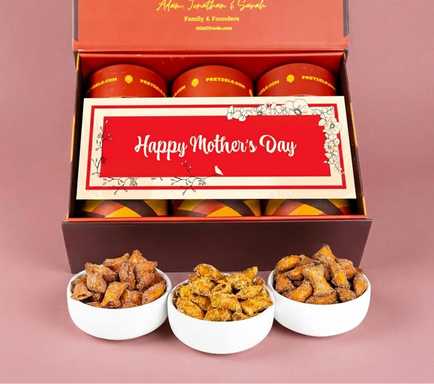 A 'Happy Mother's Day' pretzel gift box with three bowls of seasoned pretzel bites in front.