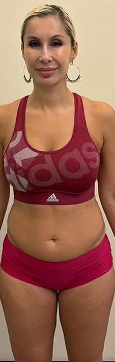 Woman in red athletic wear standing against a beige background.