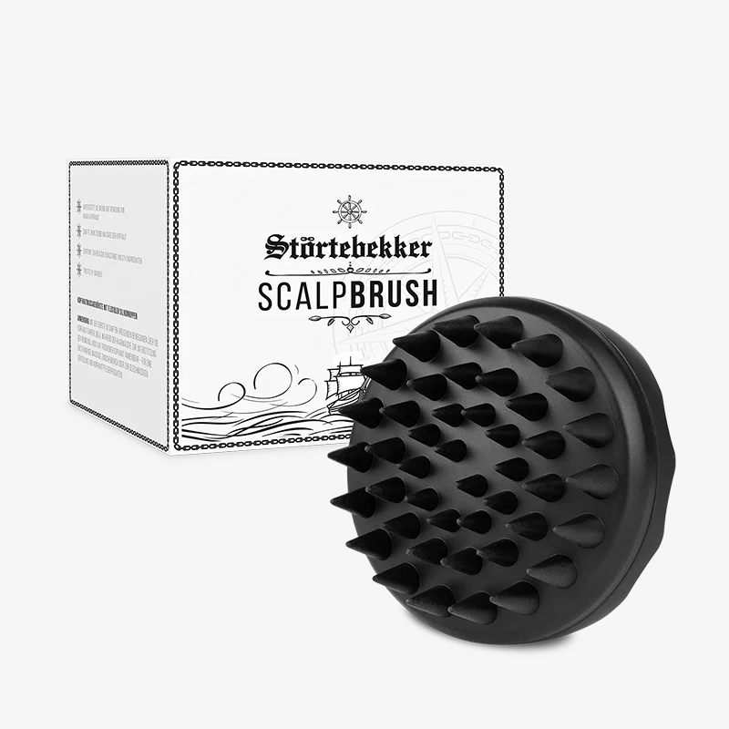 Black scalp brush in front of a white box with text.