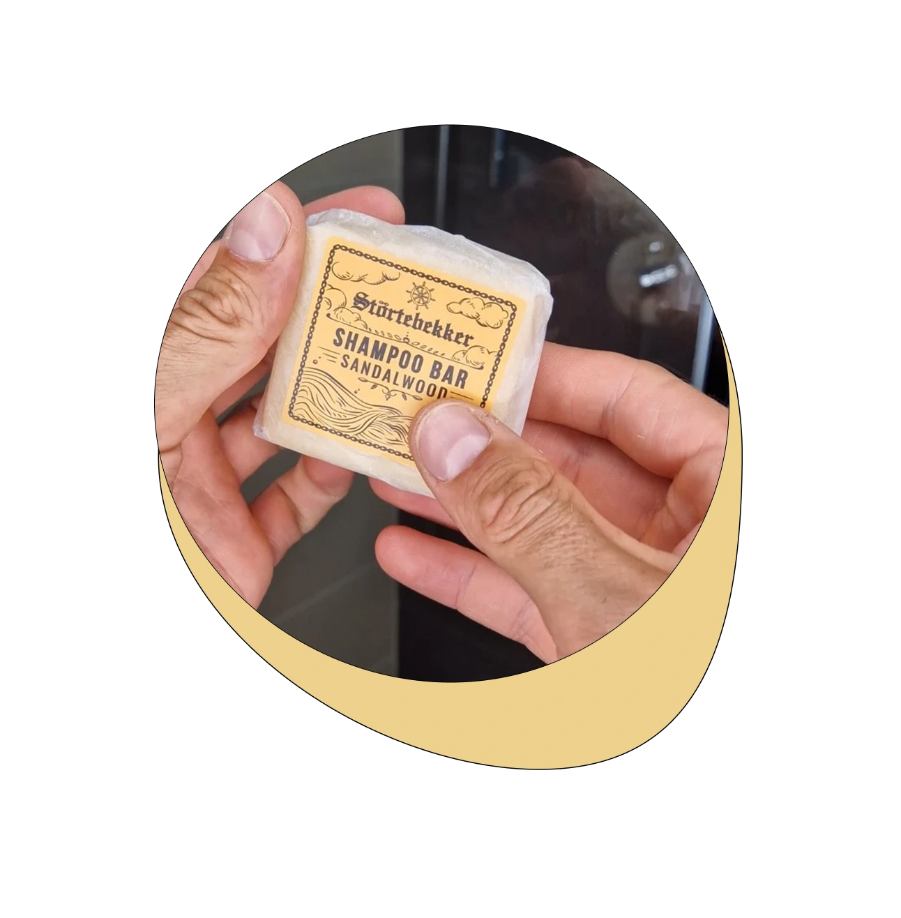 Hands holding a Störtebekker sandalwood shampoo bar.